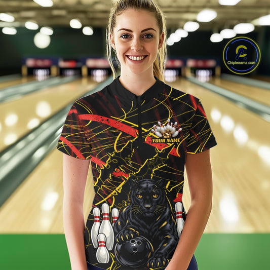 A woman wearing a custom bowling-themed short-sleeve polo shirt with a black background, yellow and red abstract lines, a black panther graphic, bowling pins, and a bowling ball. The shirt has a placeholder name on the chest.