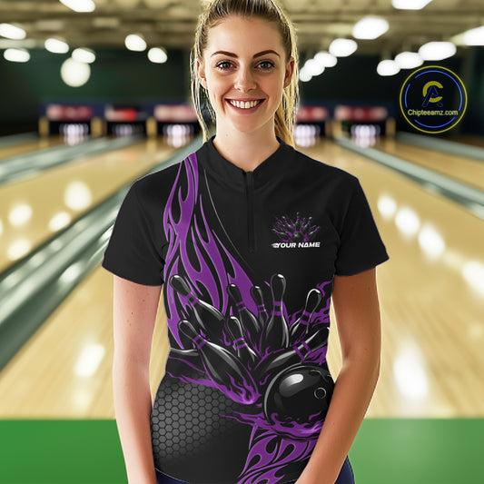Female model front view inside bowling venue wearing black quarter zip shirt with purple flame bowling ball knocking down pins illustration