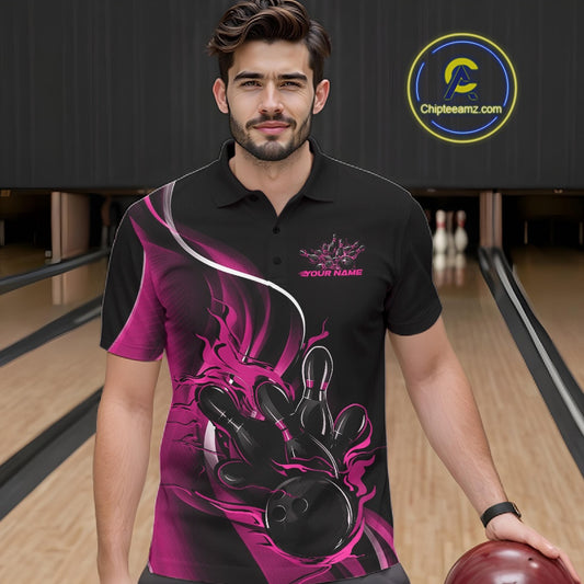 Male model seen from the front in a bowling lane wearing a black and pink polo shirt featuring a flame bowling ball striking pins in a dynamic sports action design.