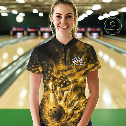 Female model at the bowling lane wearing a black and yellow quarter-zip with patriotic bowling graphics and fiery accents.