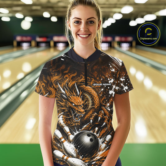 Woman wearing a bowling shirt with a dragon design in a bowling alley.