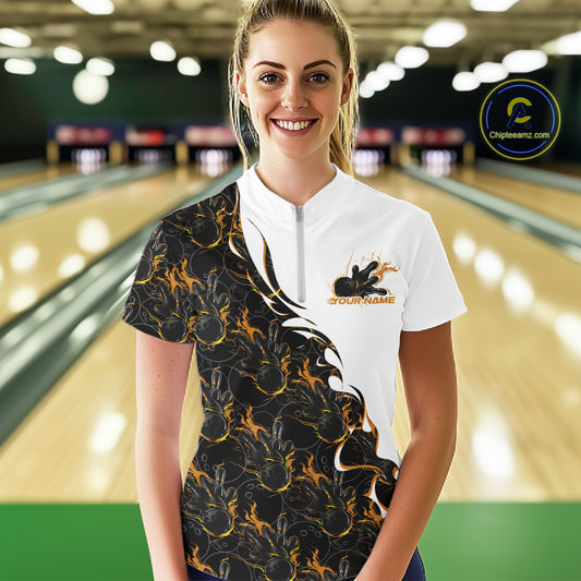 Front view of a female model in a bowling lane wearing a white quarter-zip shirt, showcasing yellow and black flame bowling pattern with energetic bowling action design.