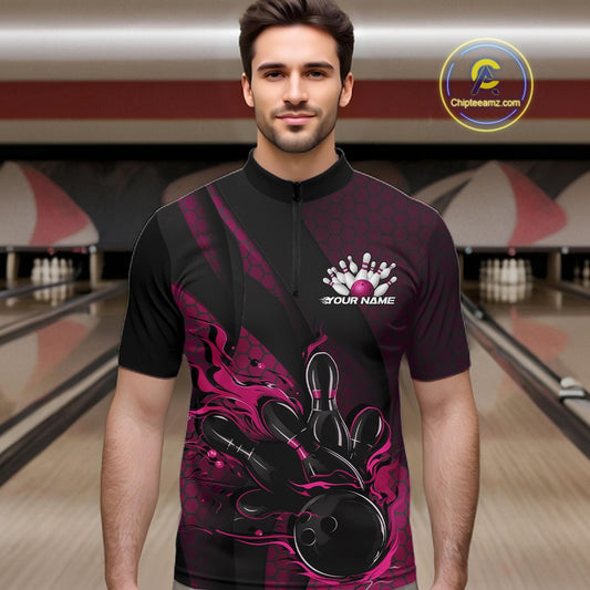Male model at a bowling lane wearing a black and pink bowling quarter-zip shirt with bowling strike artwork, geometric accents, and diagonal striping.