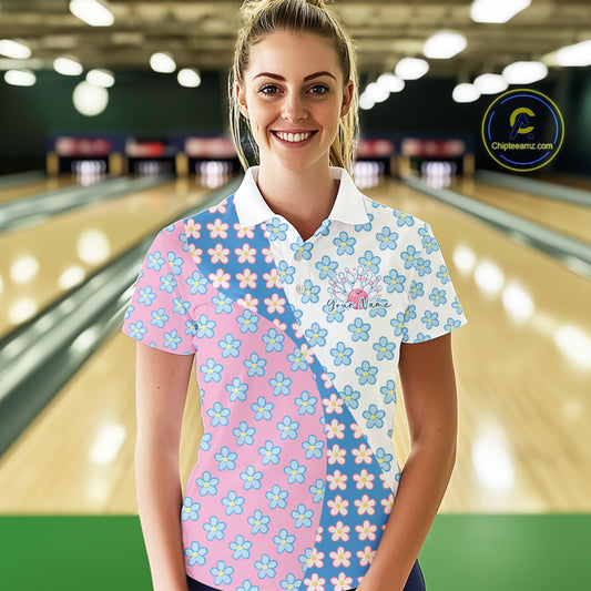 Female model at bowling lane front view wearing white polo shirt with white, blue and pink floral pattern, casual bowling center environment
