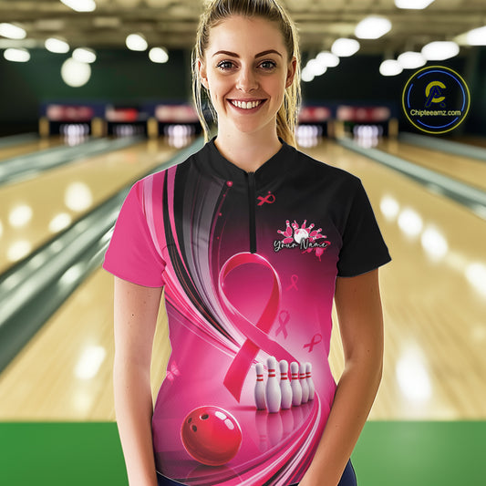 Female model wearing a black and pink bowling quarter zip with breast cancer awareness ribbons and bowling graphics, front view