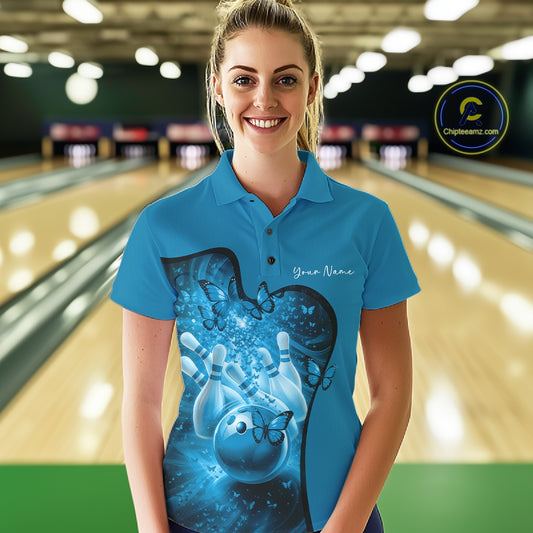 Front view of a female model wearing a blue bowling polo shirt featuring butterfly accents and bowling-themed graphics.