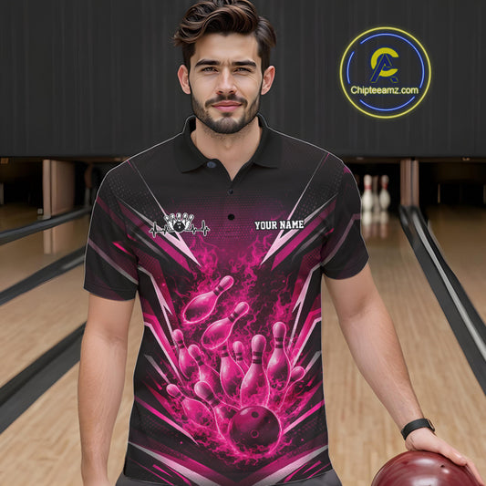 Front view of a male model at the bowling lane wearing a black and pink polo with energetic bowling strike artwork and flames.
