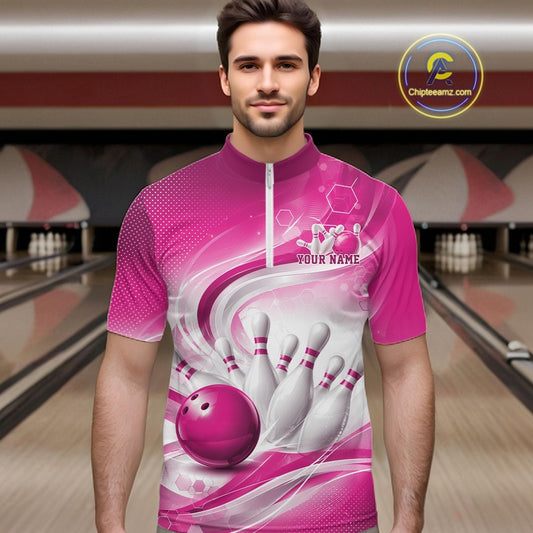 Male model standing in a bowling lane wearing a white and pink bowling quarter-zip shirt featuring abstract wave lines and a glossy bowling ball striking pins on the front.