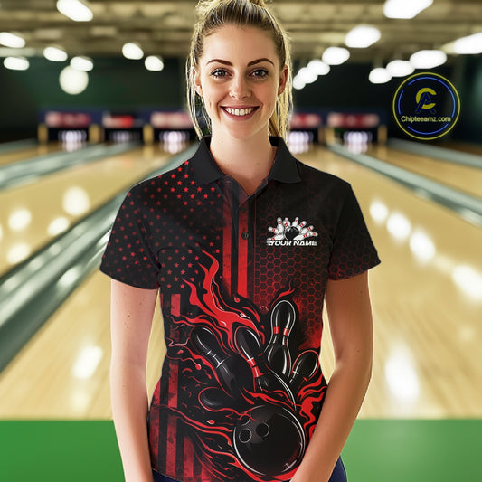 Female model wearing a black and red bowling polo shirt at a bowling lane with fiery bowling-themed graphics and patriotic styling.
