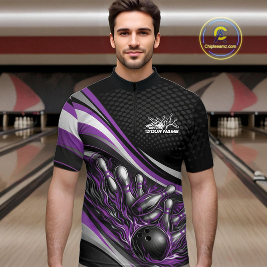 Male model at a bowling lane wearing a black and purple quarter-zip shirt, fiery bowling ball hitting pins with bold graphic impact.