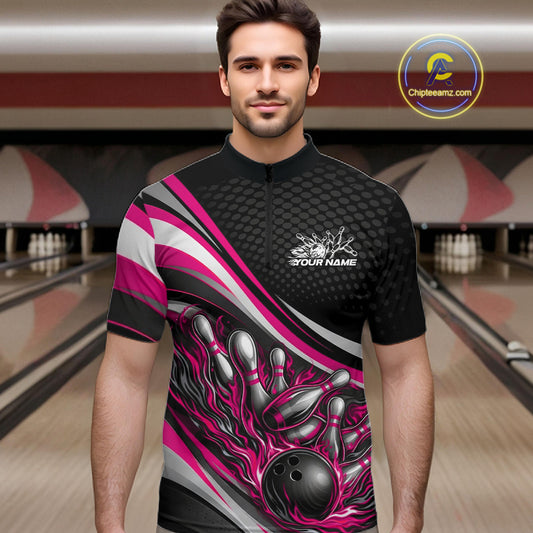 Male model at a bowling lane wearing a black and pink quarter-zip shirt, flame bowling ball striking pins with energetic motion graphics.