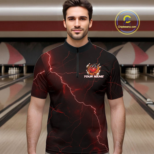 Male model at the bowling lane wearing a black and red quarter-zip with dragon claw artwork and fiery bowling elements.