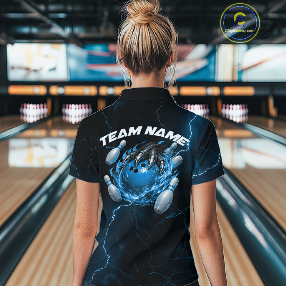 Back view of a black and blue womens bowling polo showcasing a dragon claw holding a flaming bowling ball with fantasy-inspired details.