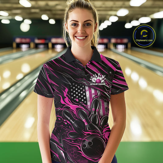 Female model wearing a black and pink bowling polo shirt at a bowling lane with fiery bowling strike artwork and patriotic accents.