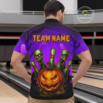 A man viewed from behind wearing a short-sleeve bowling shirt with a Halloween graphic. The shirt features a purple and black gradient background with three green zombie fingers reaching up from a carved orange jack-o'-lantern, plus the text 'TEAM NAME' in orange.