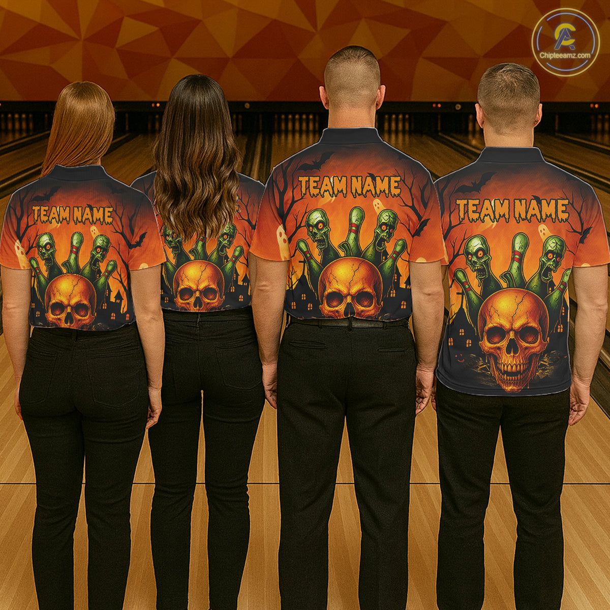 Four people standing with their backs to the camera in a bowling alley, wearing matching dark short-sleeve shirts with a large Halloween-themed graphic print featuring skulls, green ghoulish faces, bats, and the text 'TEAM NAME'.