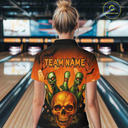 A woman viewed from behind wearing a short-sleeve bowling shirt with a Halloween-themed graphic print. The shirt features a large orange and black background with a skull, green zombie hands, and the text 'TEAM NAME'.