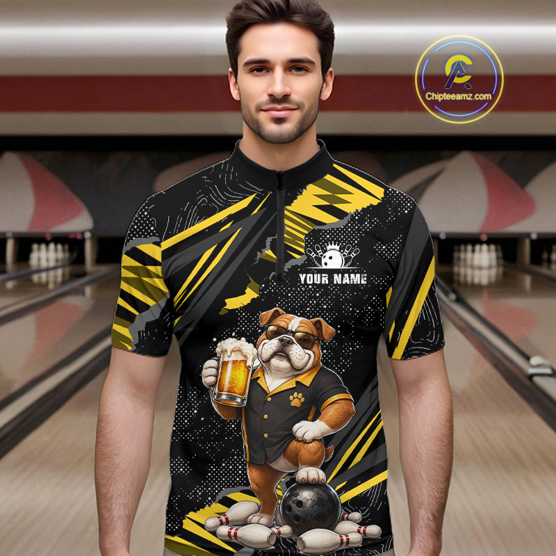 A man wearing a black and yellow bowling-themed short-sleeve quarter-zip shirt with a bulldog graphic holding a beer mug and bowling pins/ball at the hem. Bowling alley background is visible