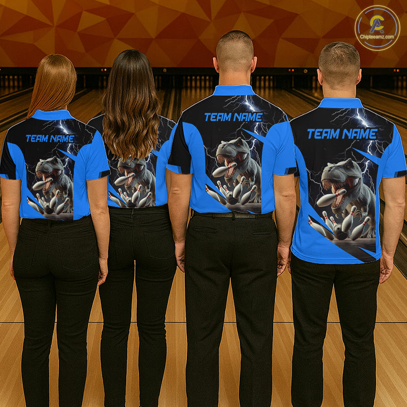 Four people standing from the back in a bowling alley, wearing matching blue and black short-sleeve shirts with a large graphic of a tiger and lightning, plus black pants. The shirts have 'TEAM NAME' printed on the back.