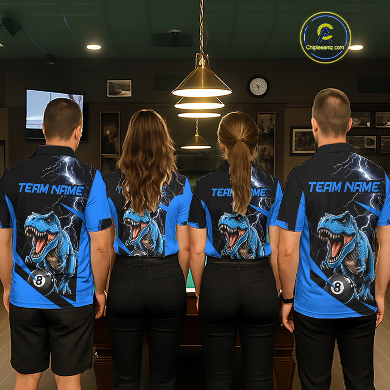 Four people standing with their backs to the camera in a billiards room, wearing matching custom team polo shirts with a blue and black dinosaur graphic on the back.