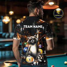 Load image into Gallery viewer, Person wearing a shirt with a raccoon design and 'TEAM NAME' text in a bar setting.