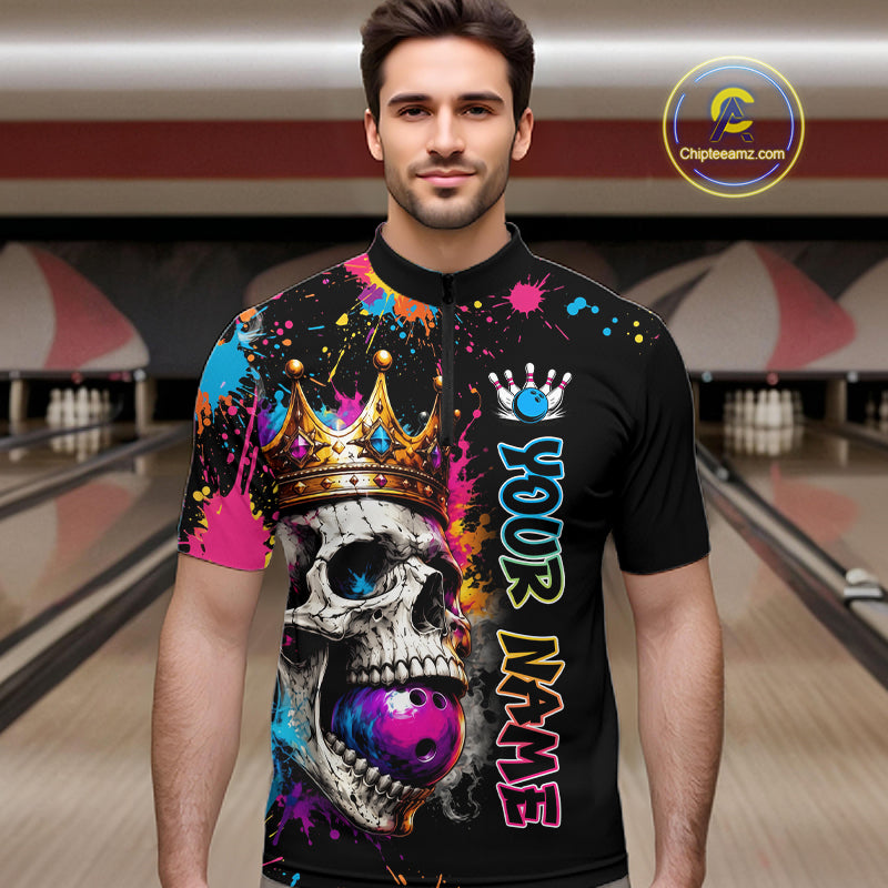 Man wearing a colorful bowling shirt with a skull design in a bowling alley.