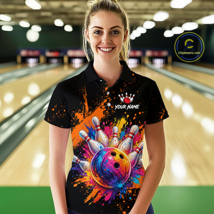 A woman stands in a bowling alley wearing a black short-sleeve polo shirt with a colorful bowling-themed graphic print featuring a multicolored bowling ball, pins, paint splatters, and a customizable name area. A circular 'Chileensemc' watermark is visible on the right side.