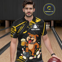 Load image into Gallery viewer, A man wearing custom black yellow bulldog bowling polo shirt front view featuring a playful cartoon mascot, bowling ball and beer mug, displaying Your Name, at the bowling alley