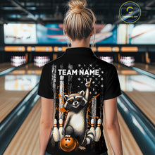 Load image into Gallery viewer, Person wearing a black shirt with a raccoon graphic and 'TEAM NAME' text in a bowling alley.