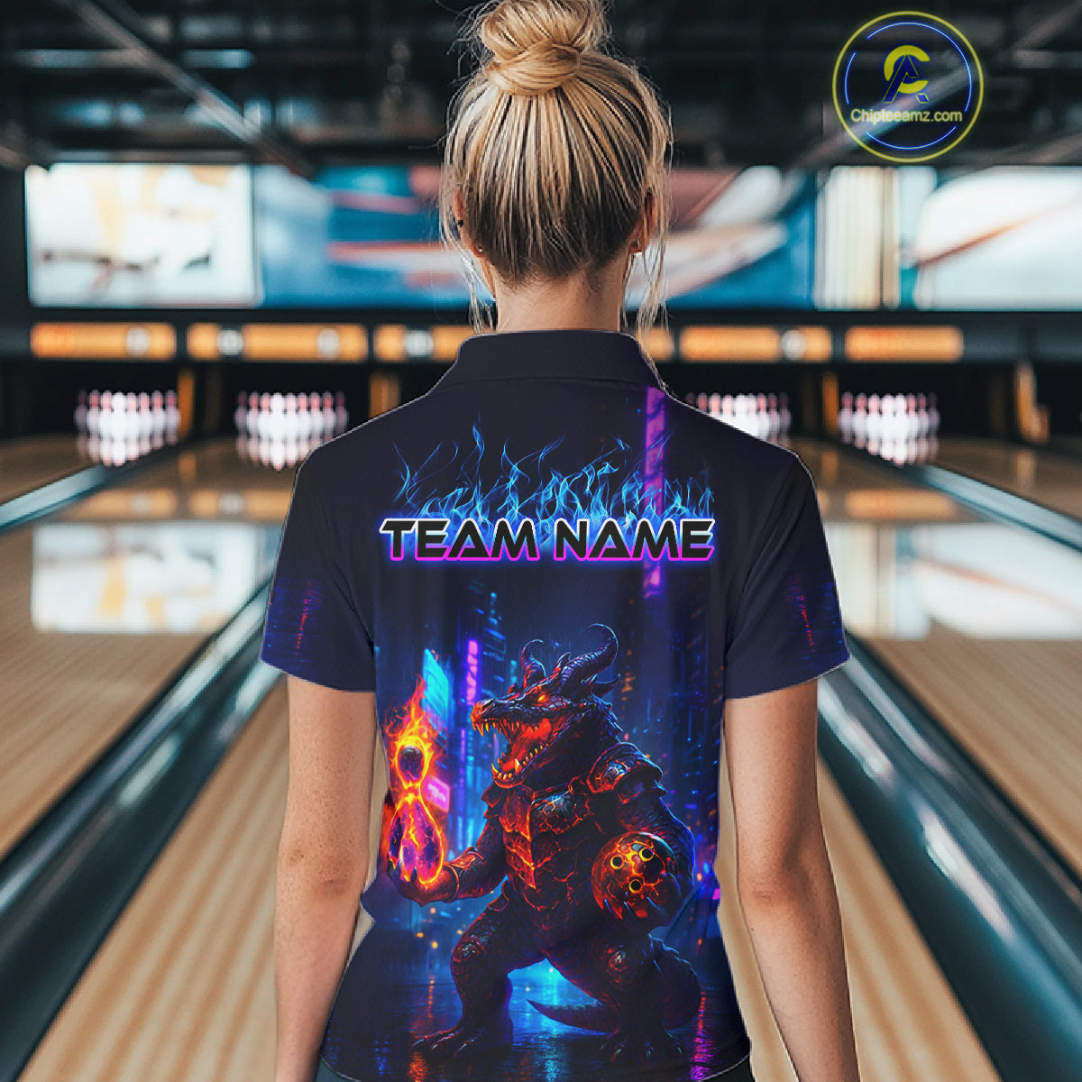 Woman wearing custom navy alligator bowling polo shirt back view featuring a glowing bowling ball and neon blue purple artwork, displaying Team Name, at the bowling alley