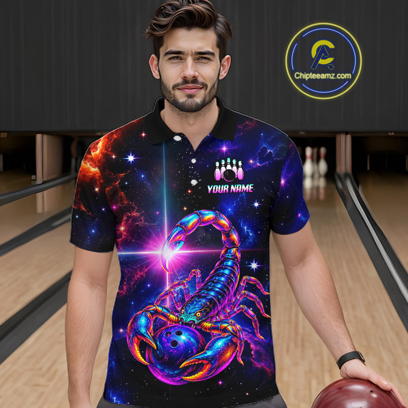A man wearing a short-sleeve bowling polo shirt with a colorful cosmic scorpion design, standing in a bowling alley. The shirt features a vibrant blue and purple scorpion on a black starry space background with a bowling pin graphic and the text 'YOUR NAME'.