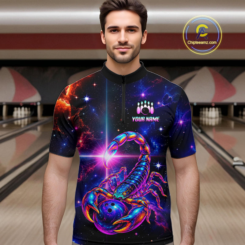 A man wearing a short-sleeve quarter-zip bowling shirt with a vibrant cosmic scorpion graphic on a bowling alley background. The shirt features a purple, blue, and orange scorpion design over a starry galaxy pattern, with a black collar and a white 'YOUR NAME' text on the chest.