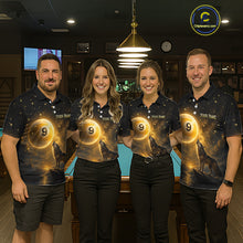 Load image into Gallery viewer, Four people standing in a dimly lit bar or lounge wearing matching dark polo shirts with a glowing gold circular graphic and the text 'Your Name' on the chest. A pool table is visible behind them
