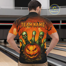 Load image into Gallery viewer, Person wearing a Halloween-themed shirt with pumpkins and zombies design in an indoor setting.