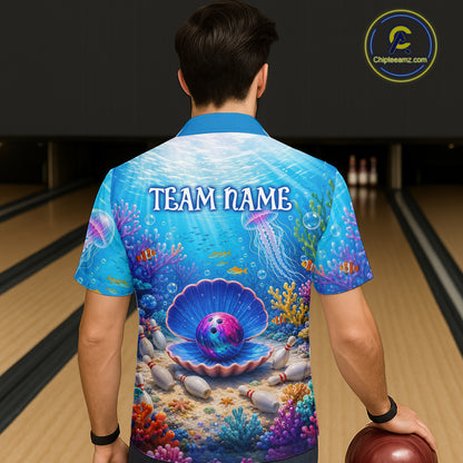 Person wearing a colorful bowling shirt with an underwater design and 'TEAM NAME' text, standing in a bowling alley.
