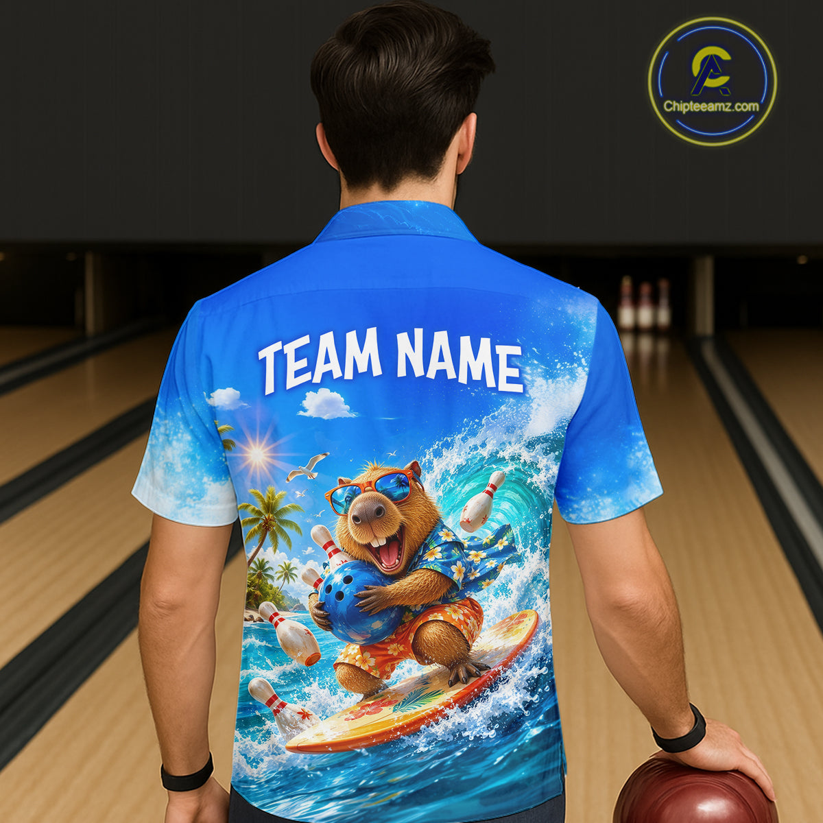 Person wearing a blue shirt with a bear bowling design and 'TEAM NAME' text on a bowling alley.
