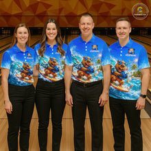 Load image into Gallery viewer, Four people wearing matching blue shirts with a bear graphic on a bowling alley.