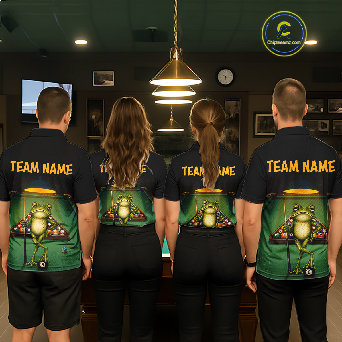 Four people standing with their backs to the camera in a dimly lit indoor room, wearing matching dark navy T-shirts with a large green pool-table graphic and yellow 'TEAM NAME' text on the back.
