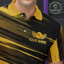 Load image into Gallery viewer, Close-up front view of a custom black gold bowling polo shirt showing the personalized player name, gold bowling ball emblem and dynamic gold brush stroke design