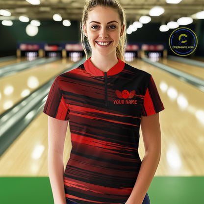 Female model wearing a custom black red bowling quarter-zip shirt front view featuring a red bowling ball emblem, dynamic red brush stroke pattern and striped design at the bowling alley
