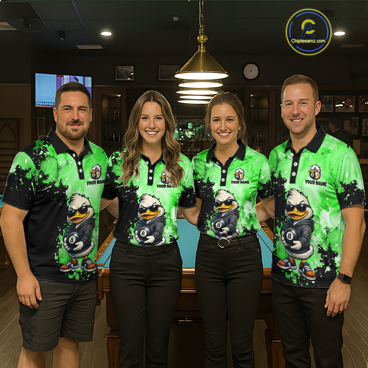 Four people standing together in a billiards or pool room wearing matching bright green and black polo shirts with a cartoon duck graphic and the text 'YOUR NAME' 
