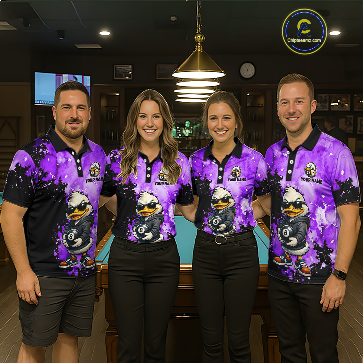 Four people standing together in a billiards or pool room wearing matching purple and black polo shirts with a cartoon duck graphic