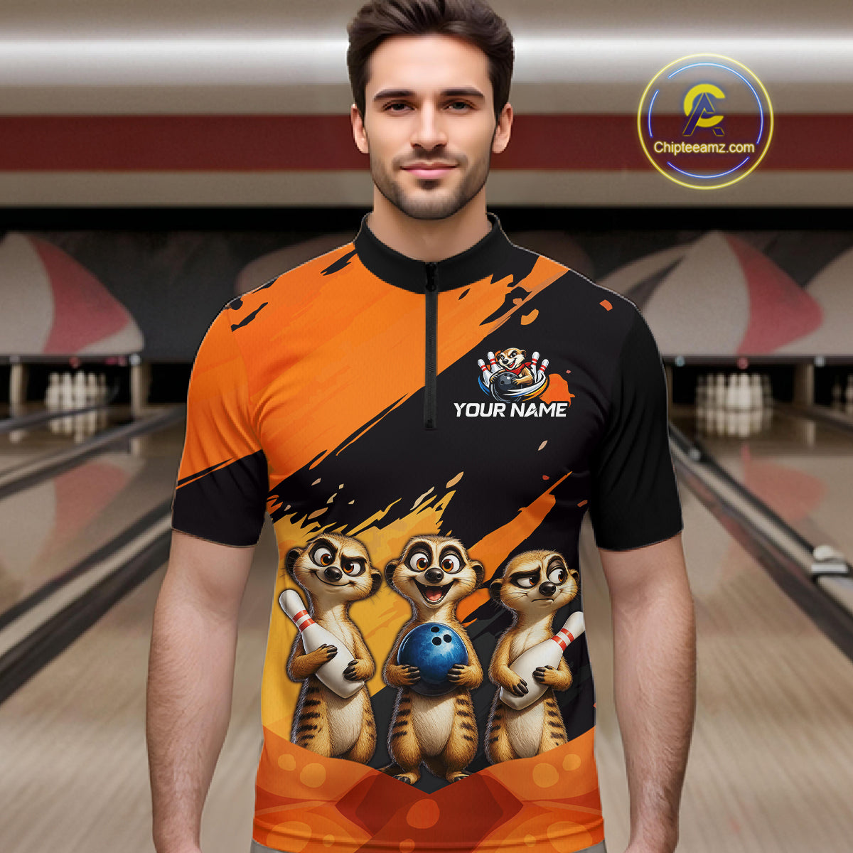 A man wearing a custom bowling-themed short-sleeve quarter-zip shirt with a black and orange diagonal design, cartoon meerkats holding bowling balls, and 'YOUR NAME' printed on the chest. The background shows a blurred bowling alley.