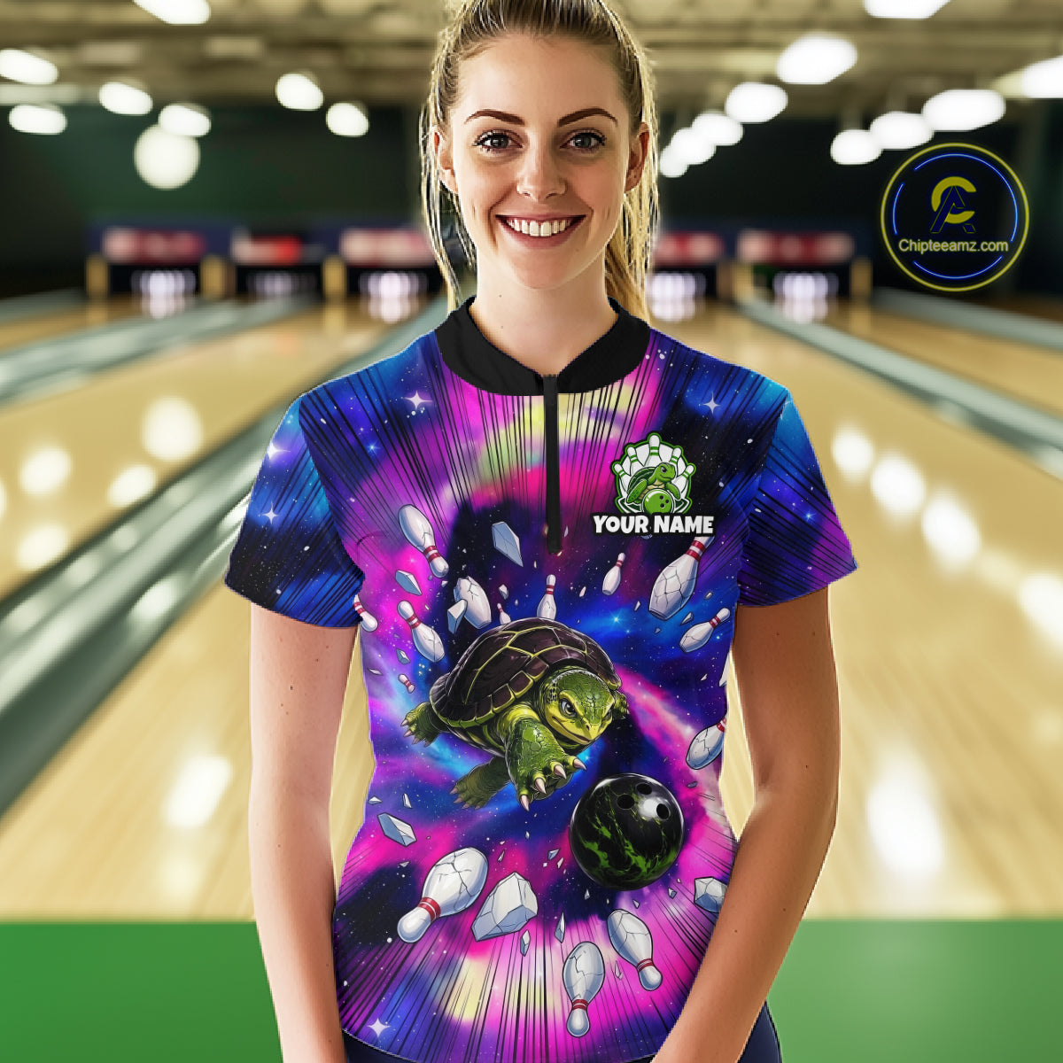 Person wearing a colorful bowling shirt with a turtle design in a bowling alley.