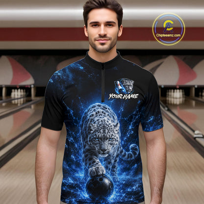 Man wearing a black t-shirt with a blue and ice leopard design in a bowling alley.