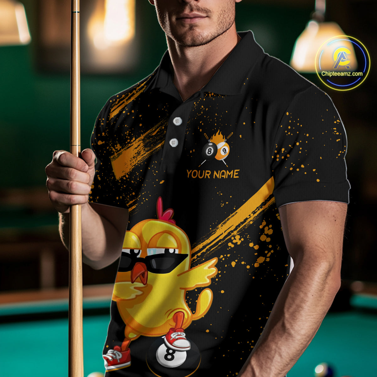 Person wearing a black polo shirt with a yellow duck graphic and pool cue in a billiards setting