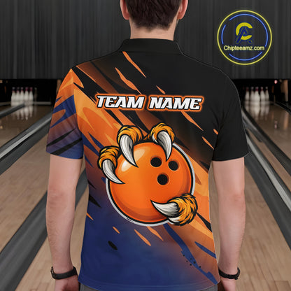 A person viewed from behind wearing a black short-sleeve bowling shirt with a large orange and blue graphic on the back featuring a cartoon clawed bowling ball and the text 'TEAM NAME'. Bowling lanes are visible in the background