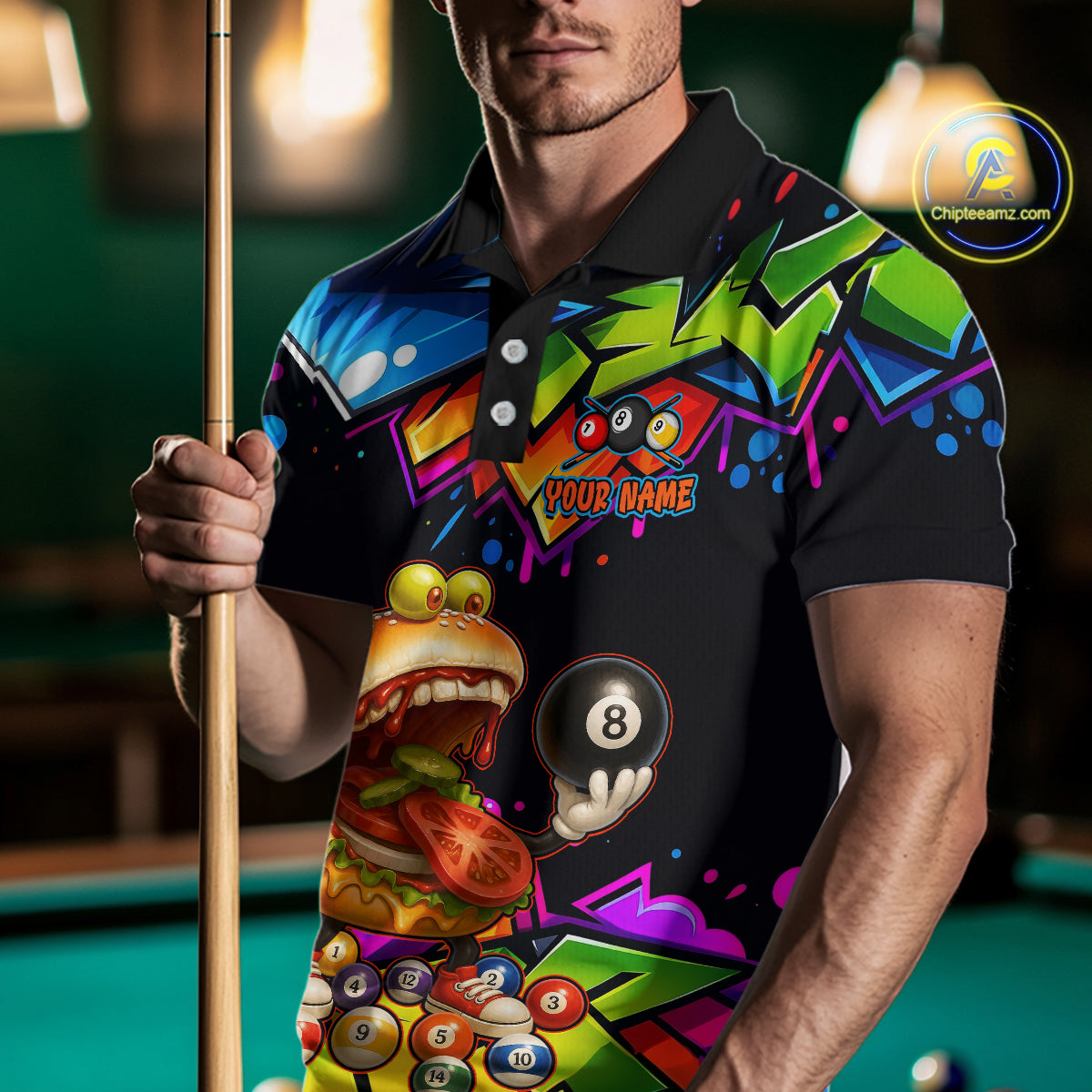 Person wearing a colorful polo shirt with a pool ball design, holding a pool cue.