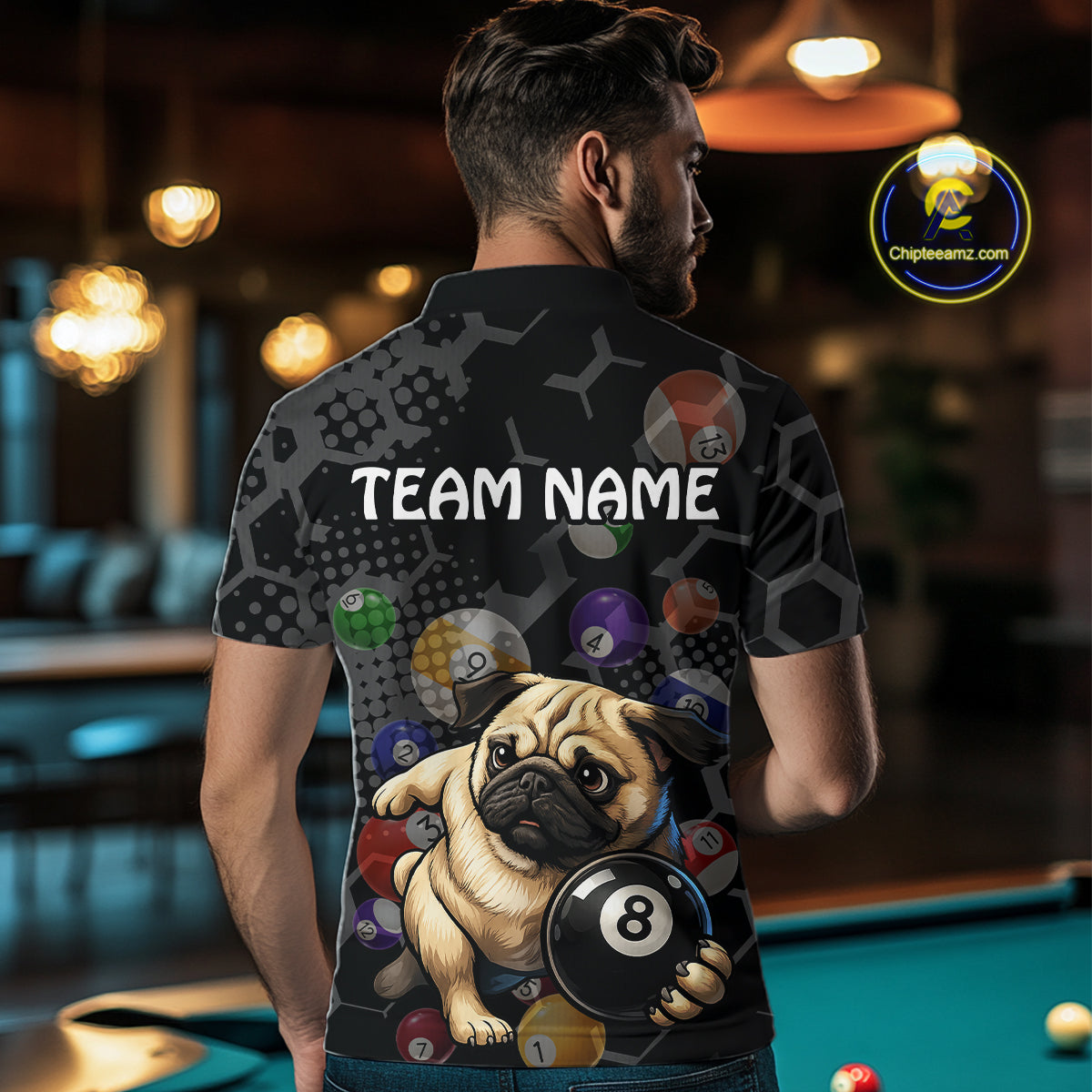 Person wearing a shirt with a pug holding a pool ball design in a bar setting.