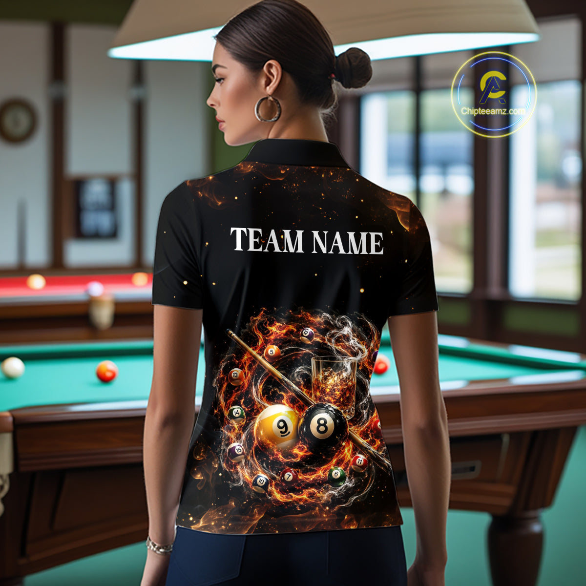 Person wearing a black shirt with a pool-themed design and 'Team Name' text in a billiard room.